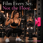 Woman squatting with a barbell as a pink Lift Hotter magnetic gym phone mount films her set from the rack, not the floor